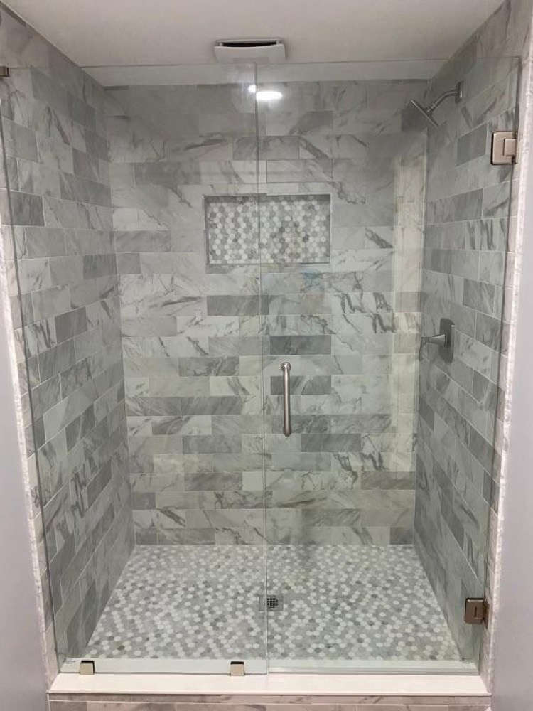 Marble tile shower with glass door