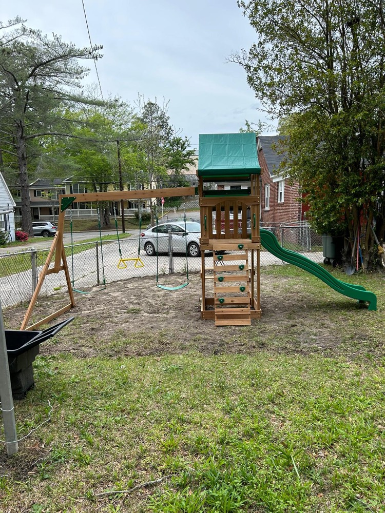 Wooden kids playset assembled in a yard
